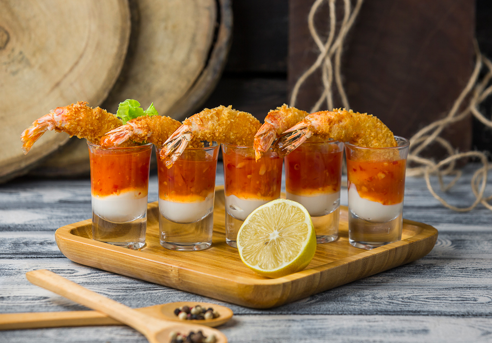 fried shrimp cocktail shots filled with mayonnaise and sweet chili sauce, close up