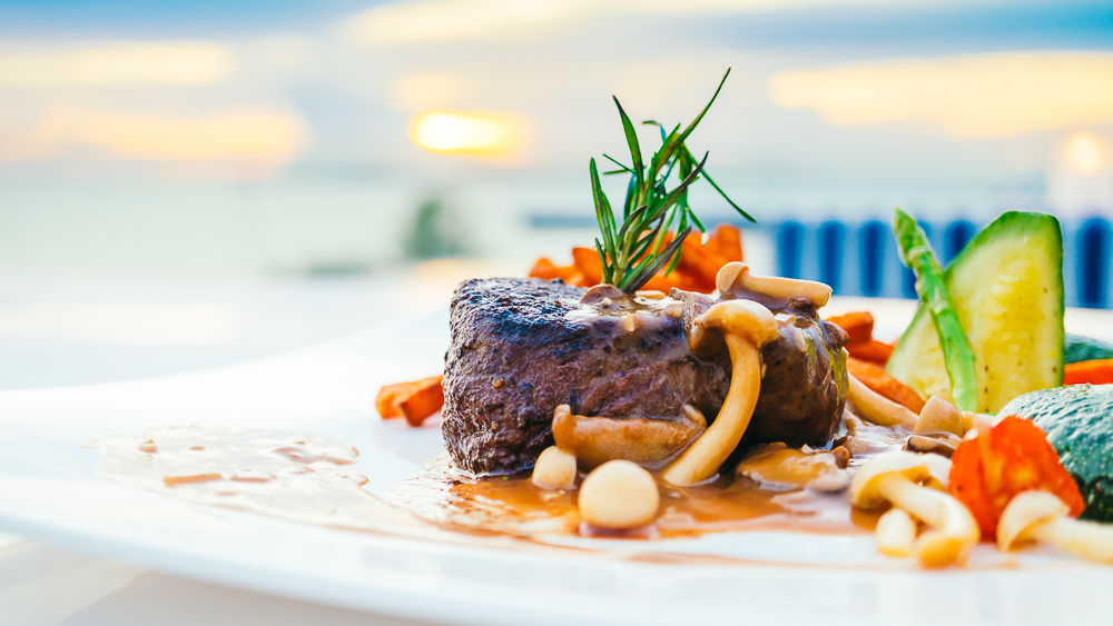 Grilled beef tenderloin meat steak with vegetable in white plate - Color Filter Processing
